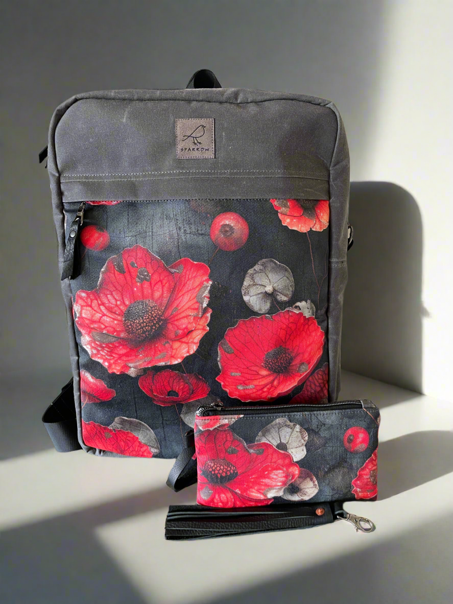 Gray backpack with red poppy design on a gray background