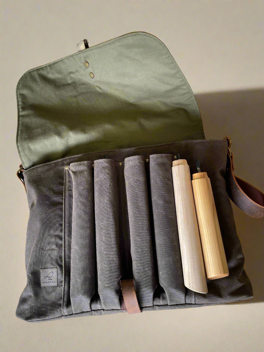 Attune crossbody bag in chocolate waxed canvas and olive green denim lining, for birthing stool. Leather strap, 4 leg pockets.