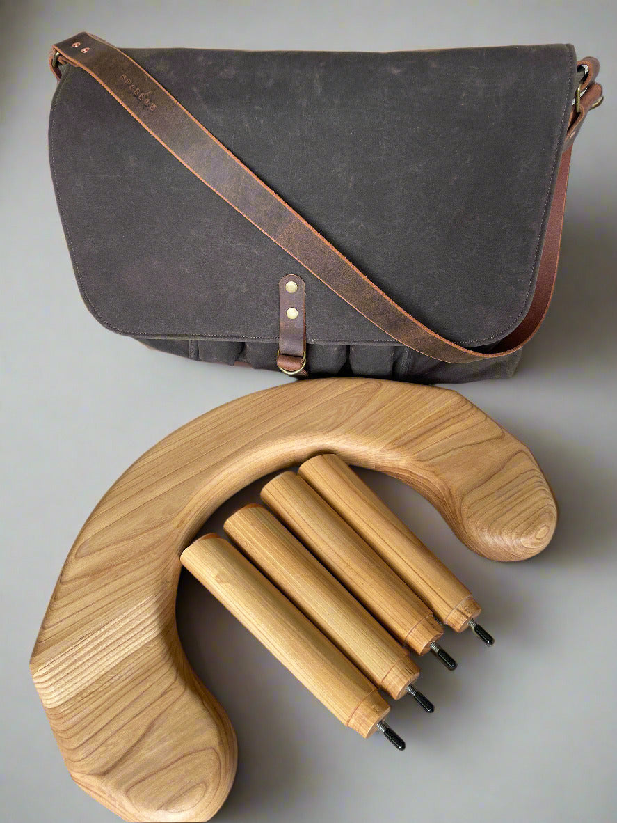 Attune crossbody bag in chocolate waxed canvas and olive green denim lining, for birthing stool. Leather strap, 4 leg pockets.