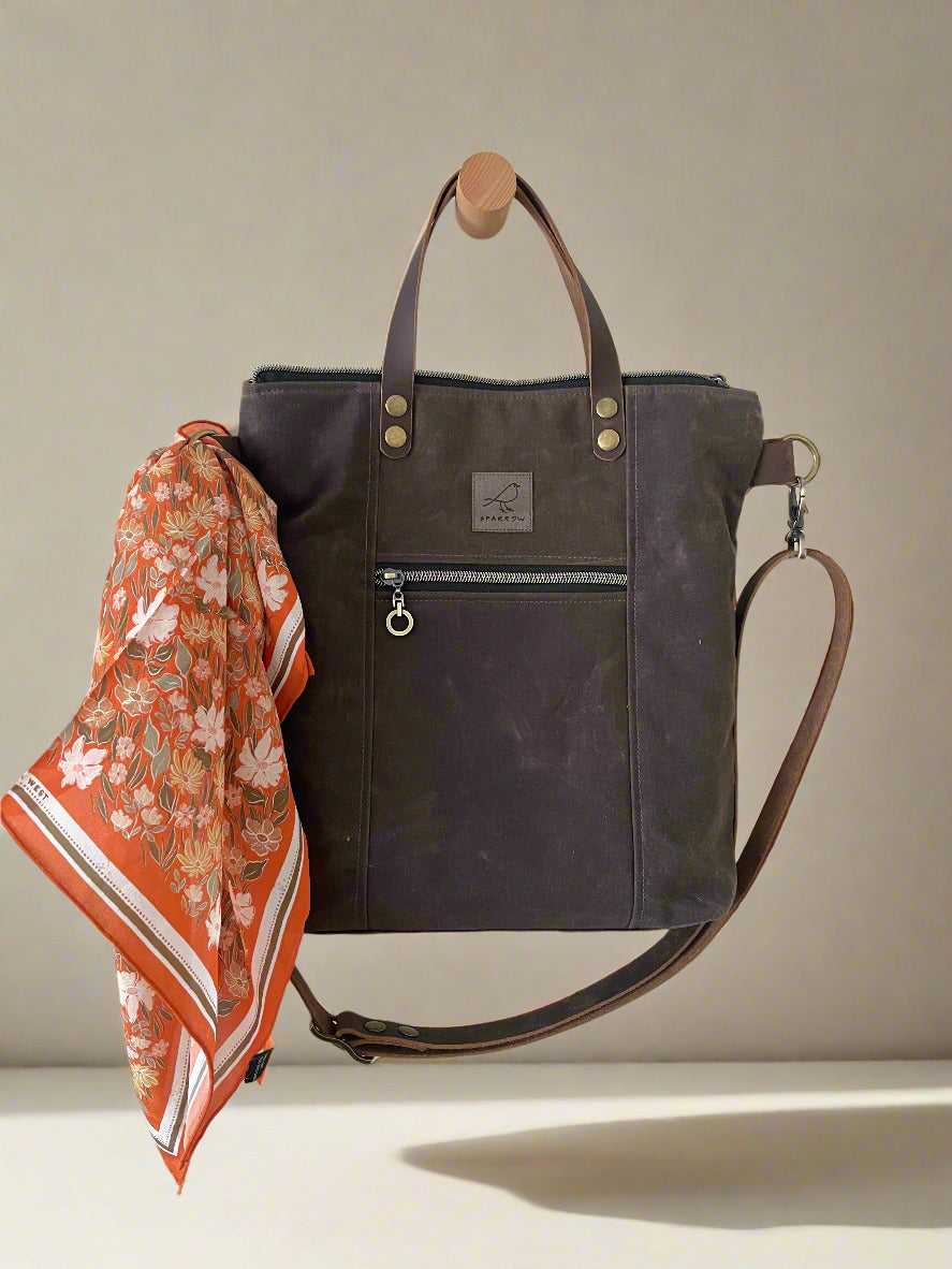 Botanical Garden silk scarf tied to Cedar Tote multipocketed crossbody tote bag in dark brown waxed canvas. Leather strap and handles, fully lined and zippered top closure. Ready to ship, handcrafted in Calgary, Canada by Sparrow Handmade.