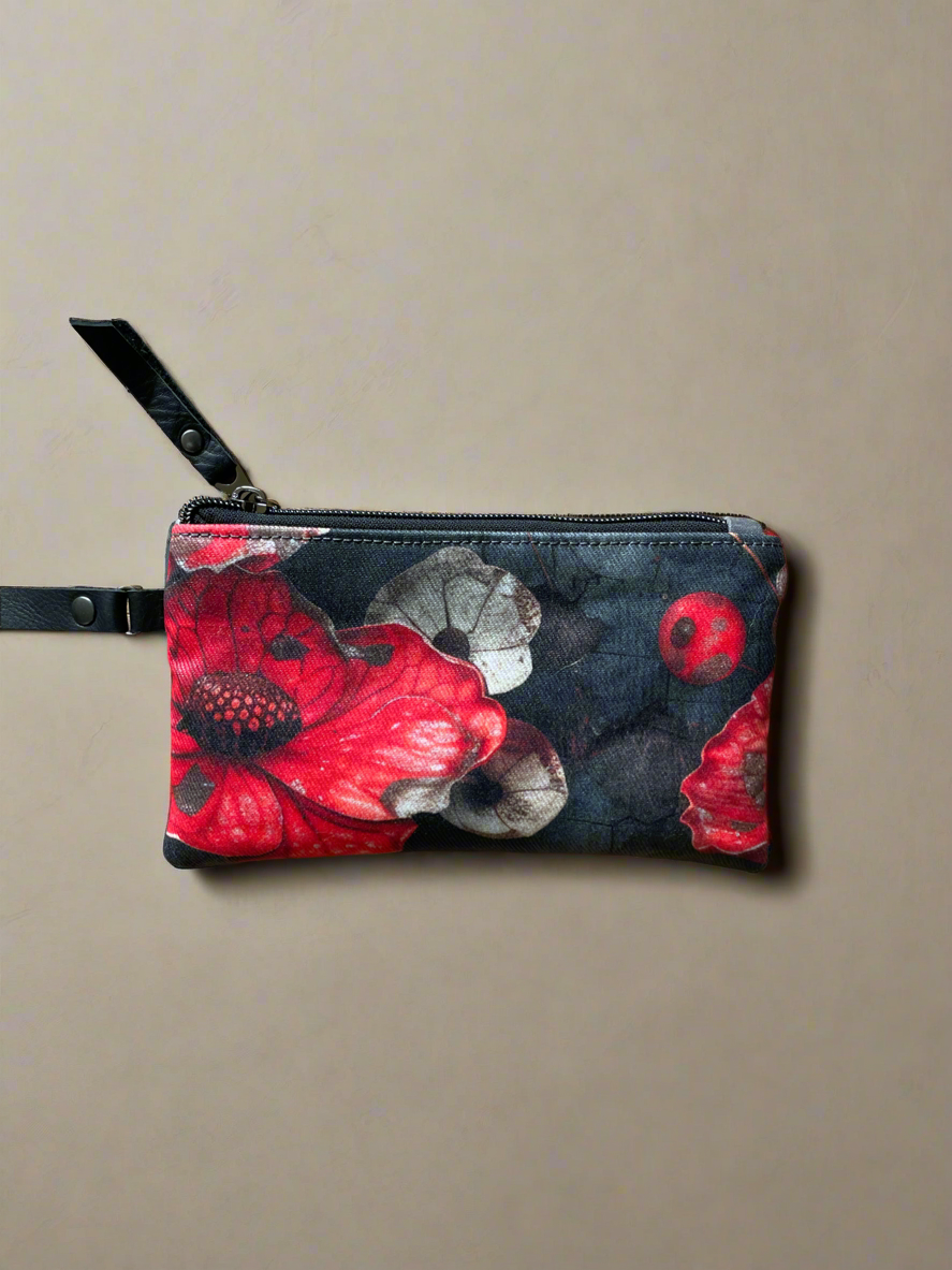Floral-patterned pouch with a strap on a beige background