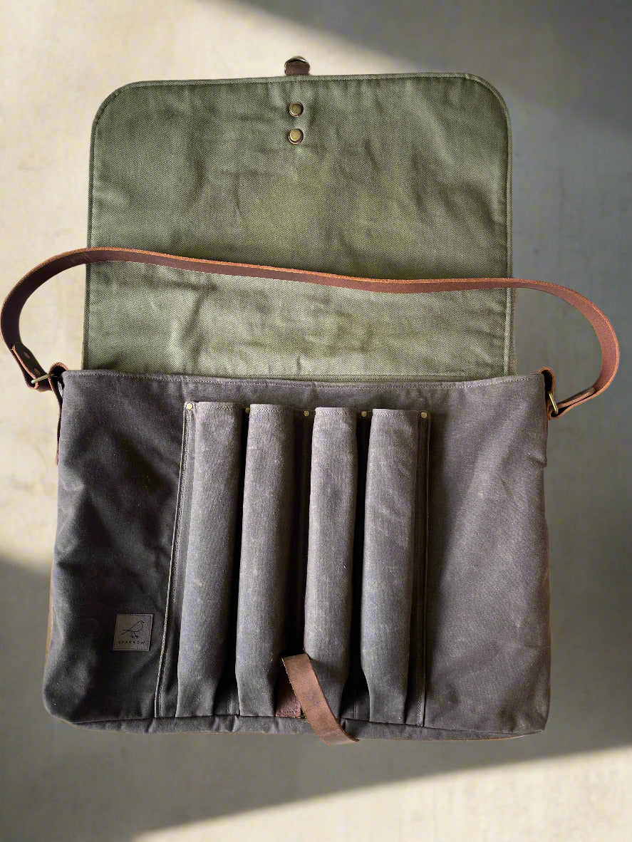 Attune crossbody bag in chocolate waxed canvas and olive green denim lining, for birthing stool. Leather strap, 4 leg pockets.