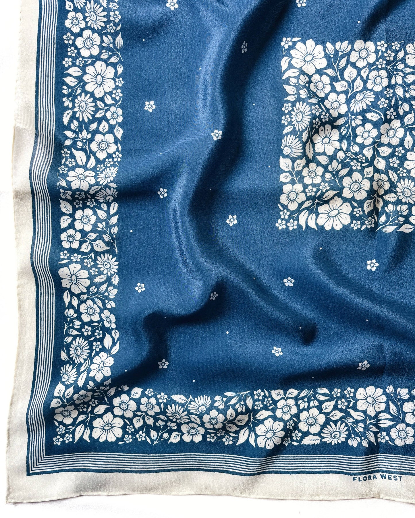 Silk scarf with blue background and white floral pattern