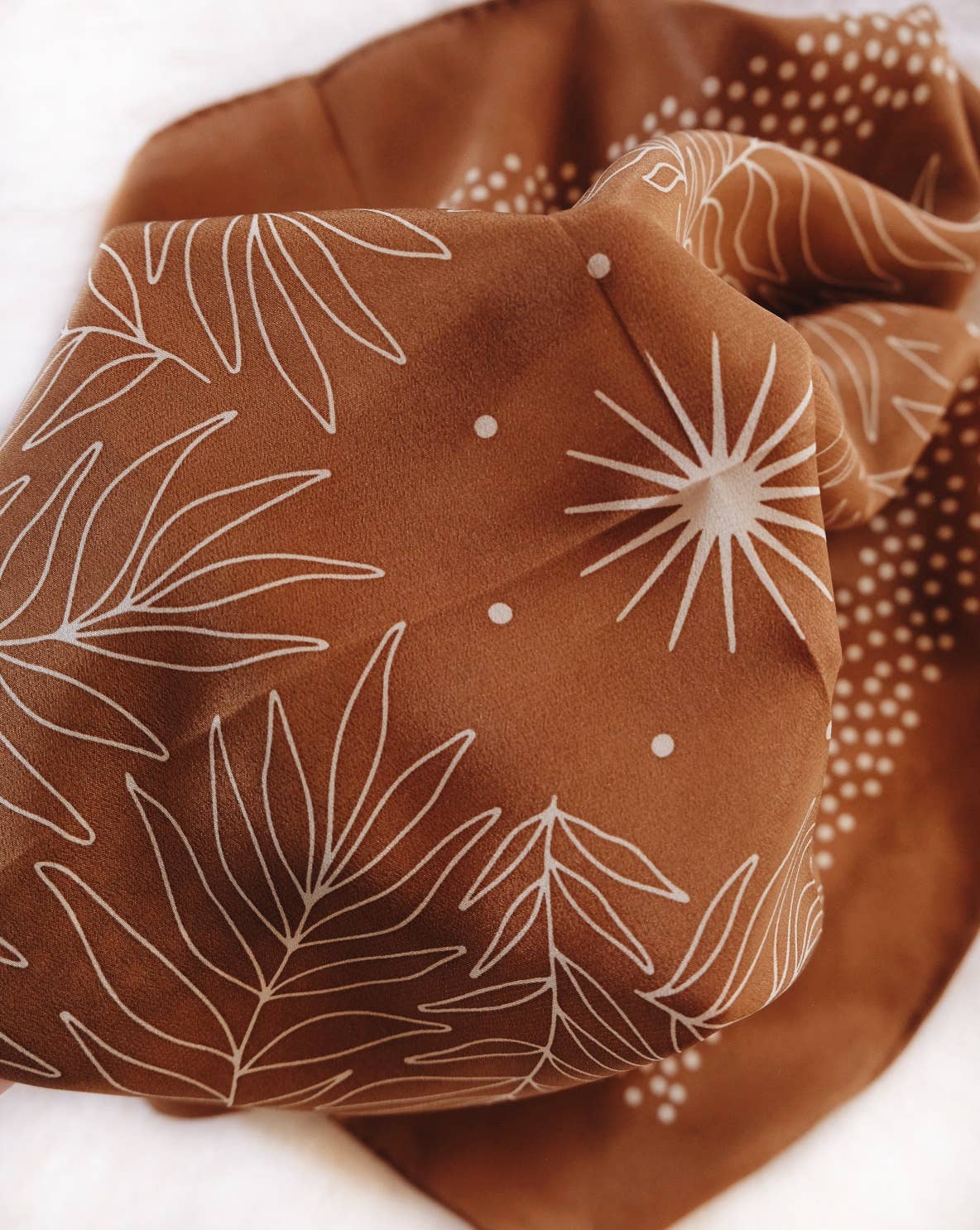 Silk scarf with brown background and white floral pattern