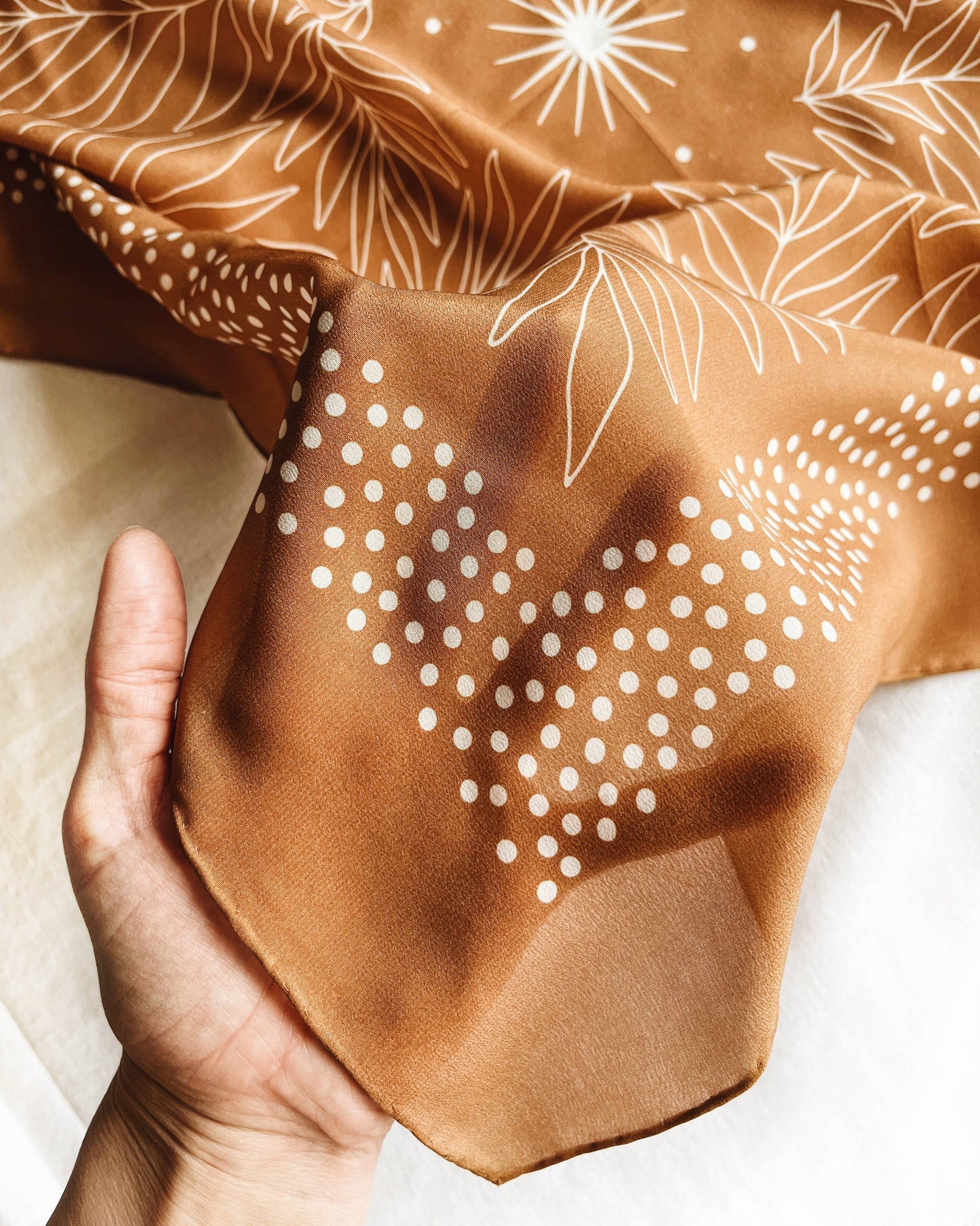 Silk scarf with brown background and white floral pattern