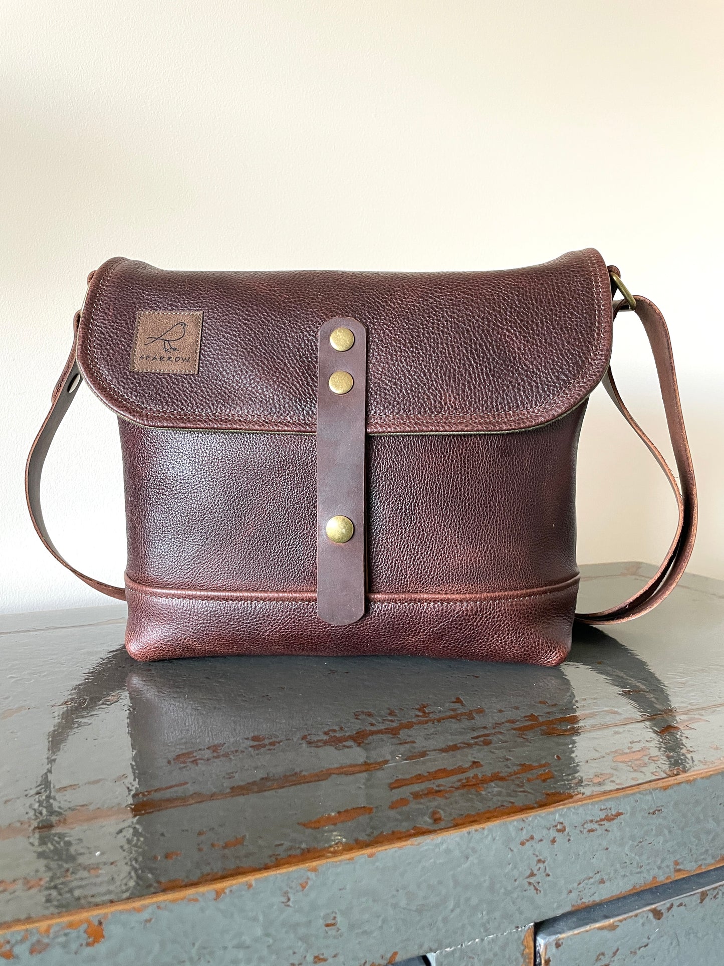 Handmade fully lined brown pebbled leather messenger bag with adjustable 1.5 inch strap. 