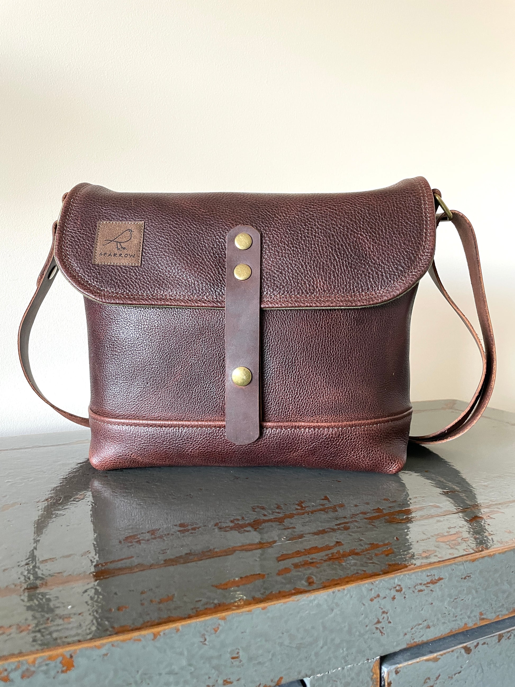 Handmade fully lined brown pebbled leather messenger bag with adjustable 1.5 inch strap. 