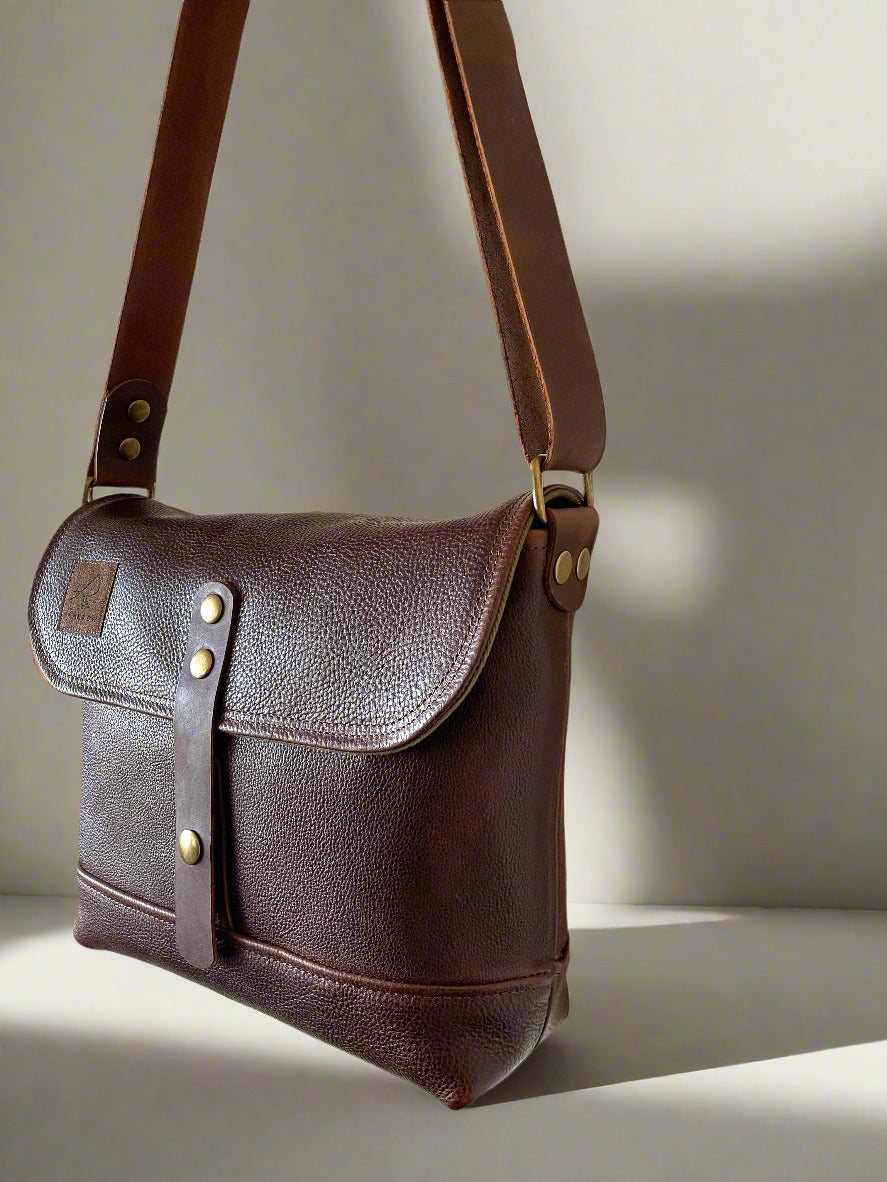 Handmade fully lined brown pebbled leather messenger bag with adjustable 1.5 inch strap. 