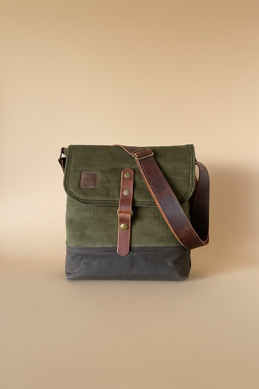 Pukka Messenger bag in olive green corduroy upper and flap, chocolate brown waxed canvas base, and brown leather 1.5" wide adjustable crossbody strap plus leather front snap closure. Handcrafted in Canada by Sparrow Handmade. 
