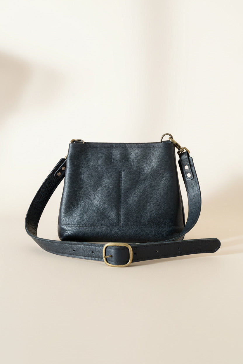 Sierra medium-sized black full-grain leather crossbody purse with adjustable strap and bronze hardwawre