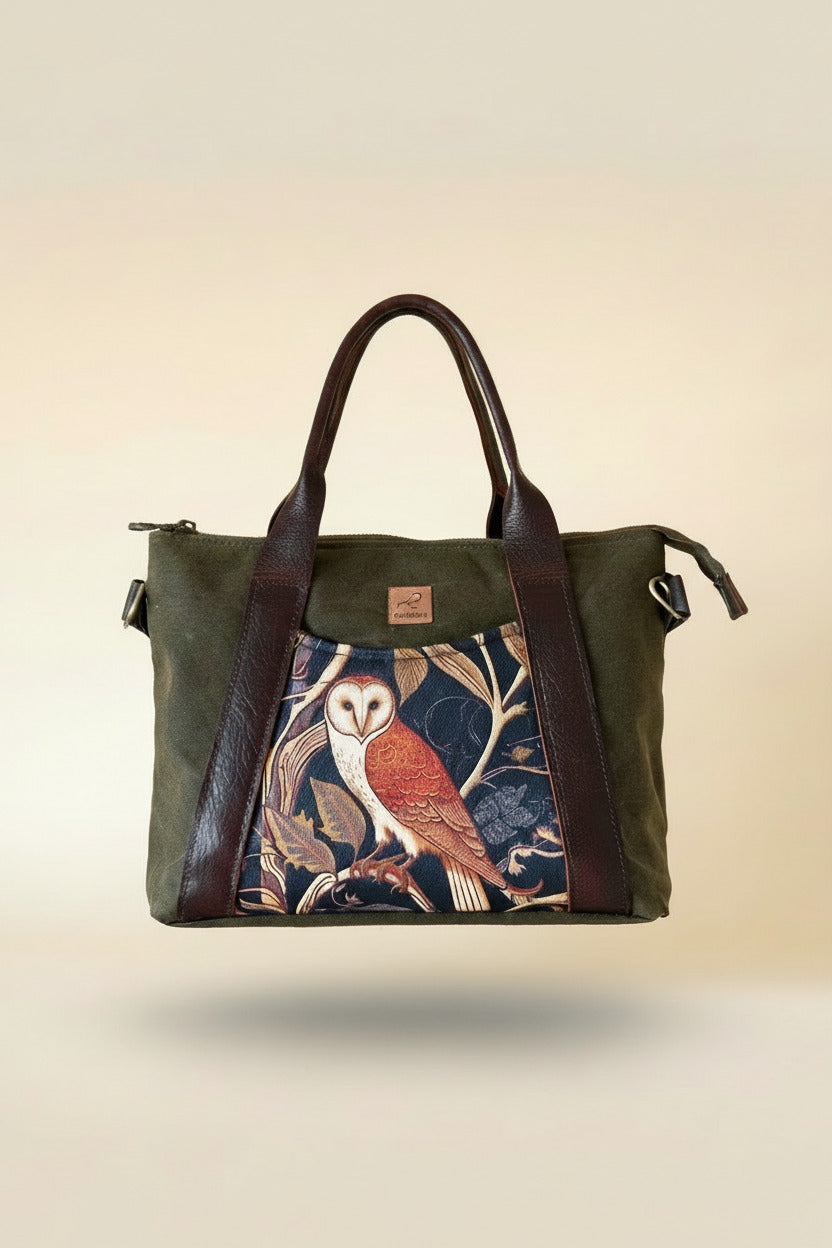 Handcrafted min Oxbow tote bag in olive grreen waxed canvas, medieval owl front pocket accent, and brown leather handles. Adjustable strap on the side. 