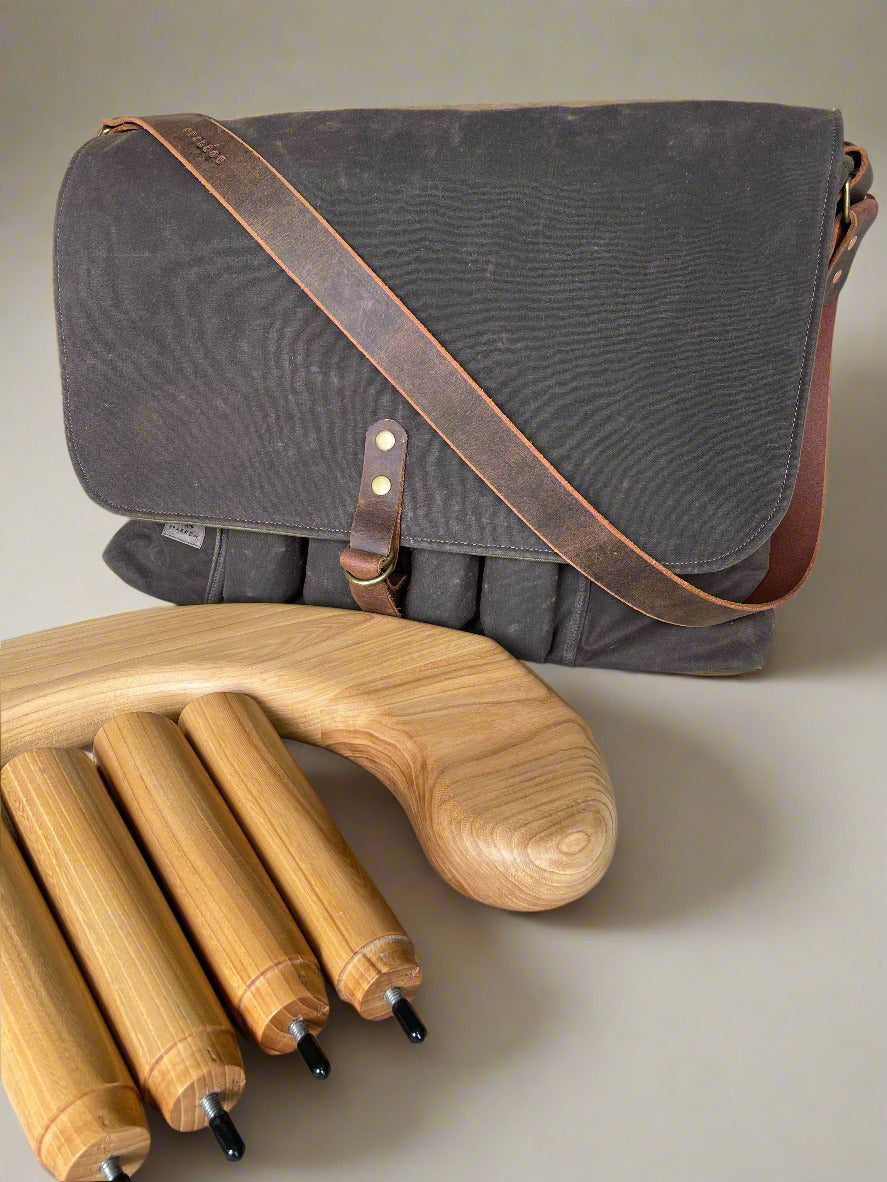 Attune crossbody bag in chocolate waxed canvas and olive green denim lining, for birthing stool. Leather strap, 4 leg pockets. Attune birthing stool and legs. 