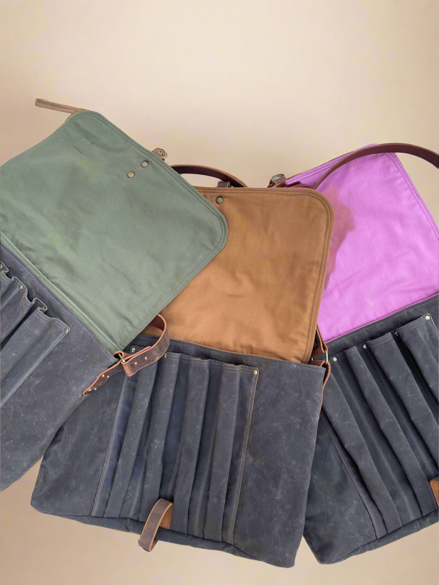 3 Attune Birthing Stool bags in chocolate waxed canvas. Interior colors are olive green, cinnamon, and blush pink. 