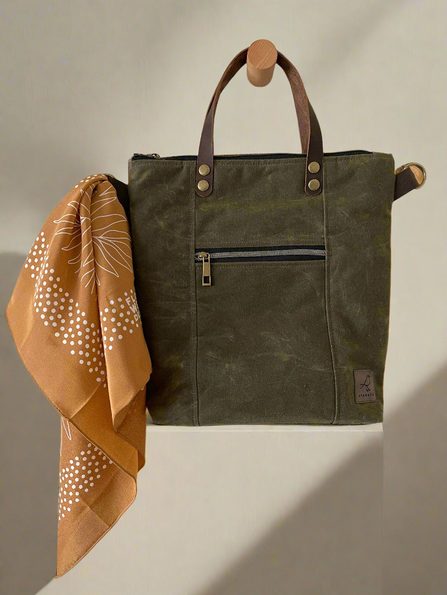 Brown silk scarf with Cedar Tote multipocketed crossbody and tote bag in olive green waxed canvas. Leather strap and handles, fully lined and zippered top closure. Ready to ship, handcrafted in Calgary, Canada by Sparrow Handmade. 