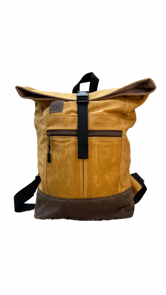 Roll-top backpack in ochre (yellow) waxed canvas and a brown waxed canvas base. Nylon webbing straps, buckle closure on top, hang tab on top. Zippered expandable front pocket. Unisex. 