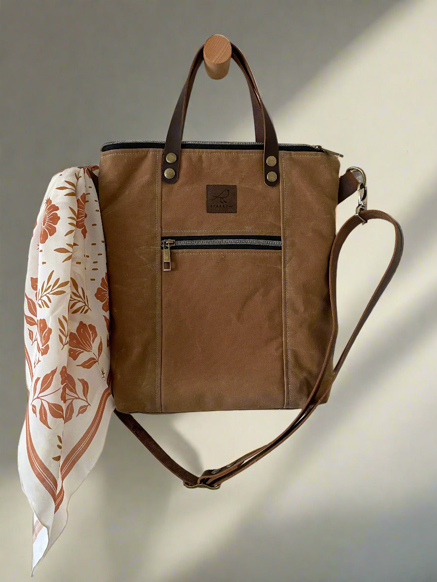 Cedar Tote multipocketed crossbody and tote bag in Field Tan waxed canvas. Leather strap and handles, fully lined zippered top closure. Ready to ship, handcrafted in Calgary, Canada by Sparrow Handmade. 