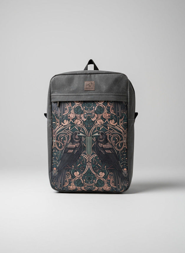 Grey waxed canvas backpack with ravens or crows print on front.