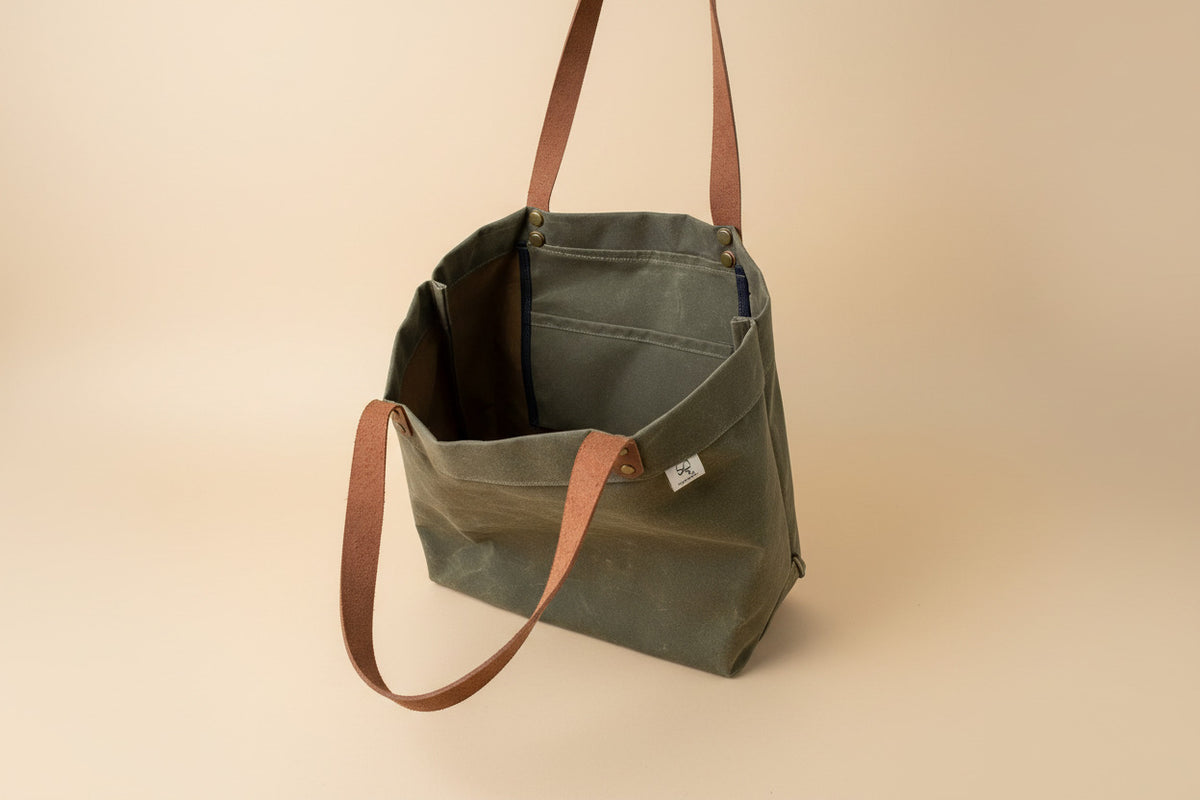 Interior view of Harvest Tote waxed canvas shopping tote, showing slip pocket and key clasp.

