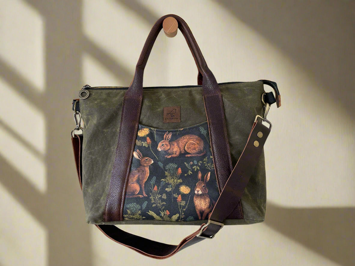 Load video: Video of me making an Oxbow crossbody/tote bag. Shows the process of working with leather, cutting the fabric, sewing, and putting it all together.