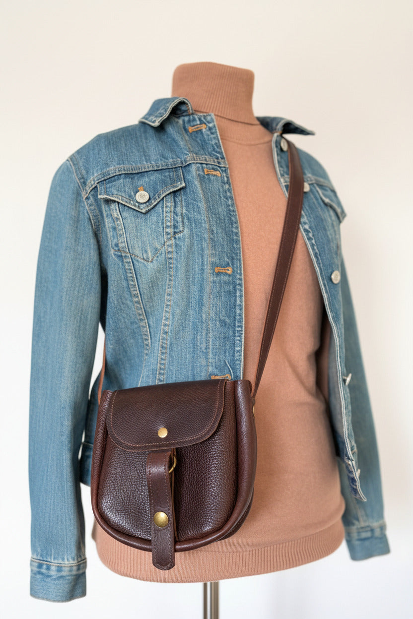 Scout small leather crossbody bag front view as worn crossbody on mannequin. 