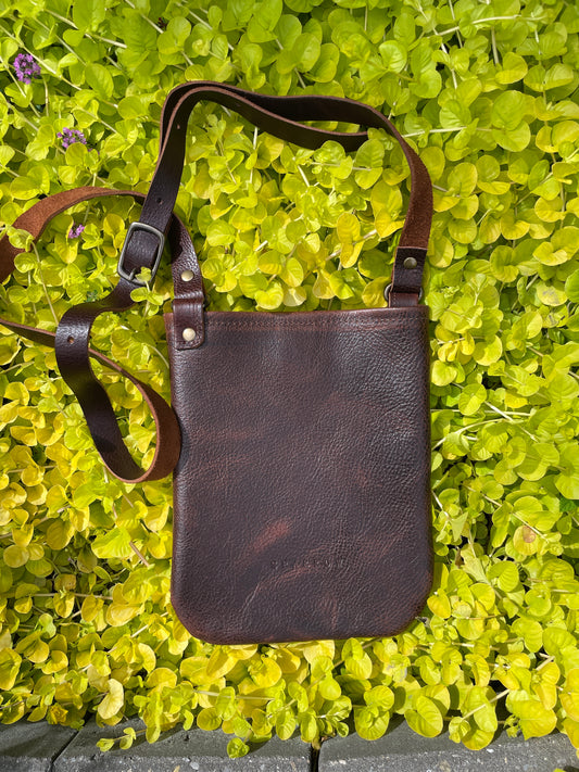 Sidekick full-grain leather small crossbody bag in "Cold Brew" leather, a dark brown. 3/4' adjustable leather strap. 