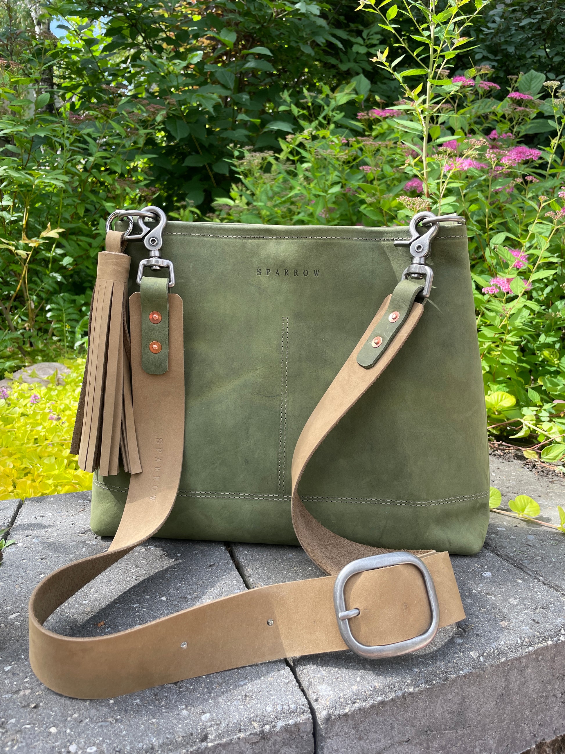Sierra full-grain leather shoulder or crossbody bag in moss green and buff. Adjustable 1.5" wide leather strap. 