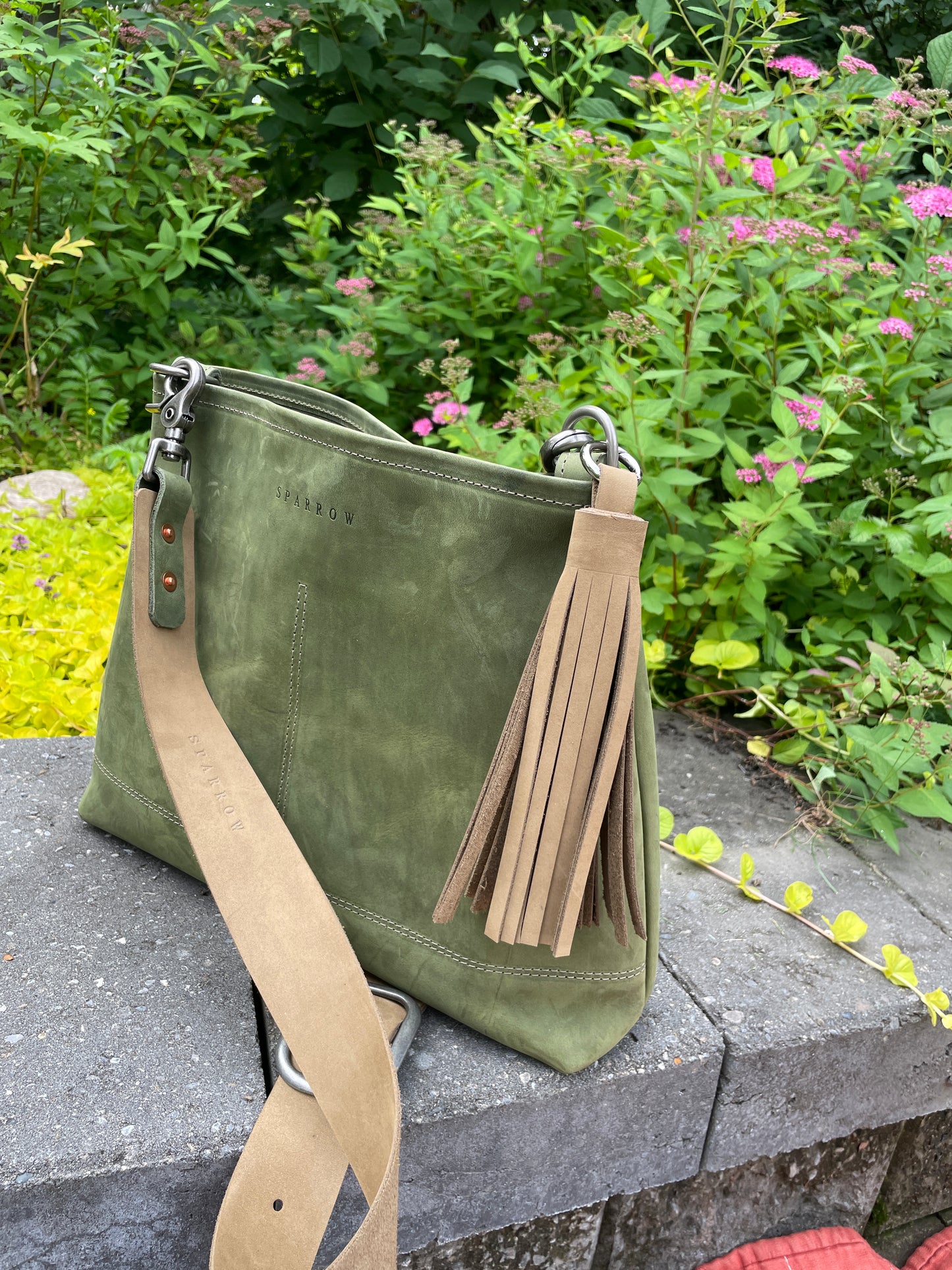 Sierra full-grain leather bag in moss green and buff and a matching tassel