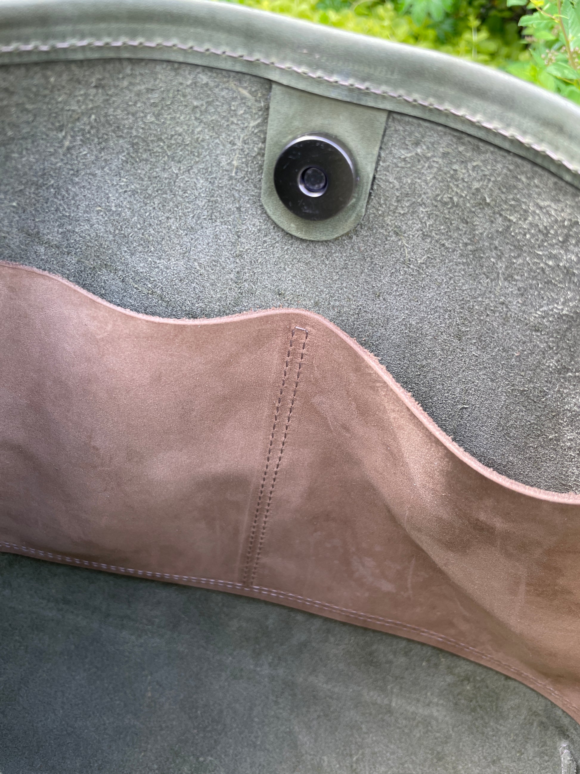 Inside of Sierra full grain leather bag showing magnetic snap and slip pockets