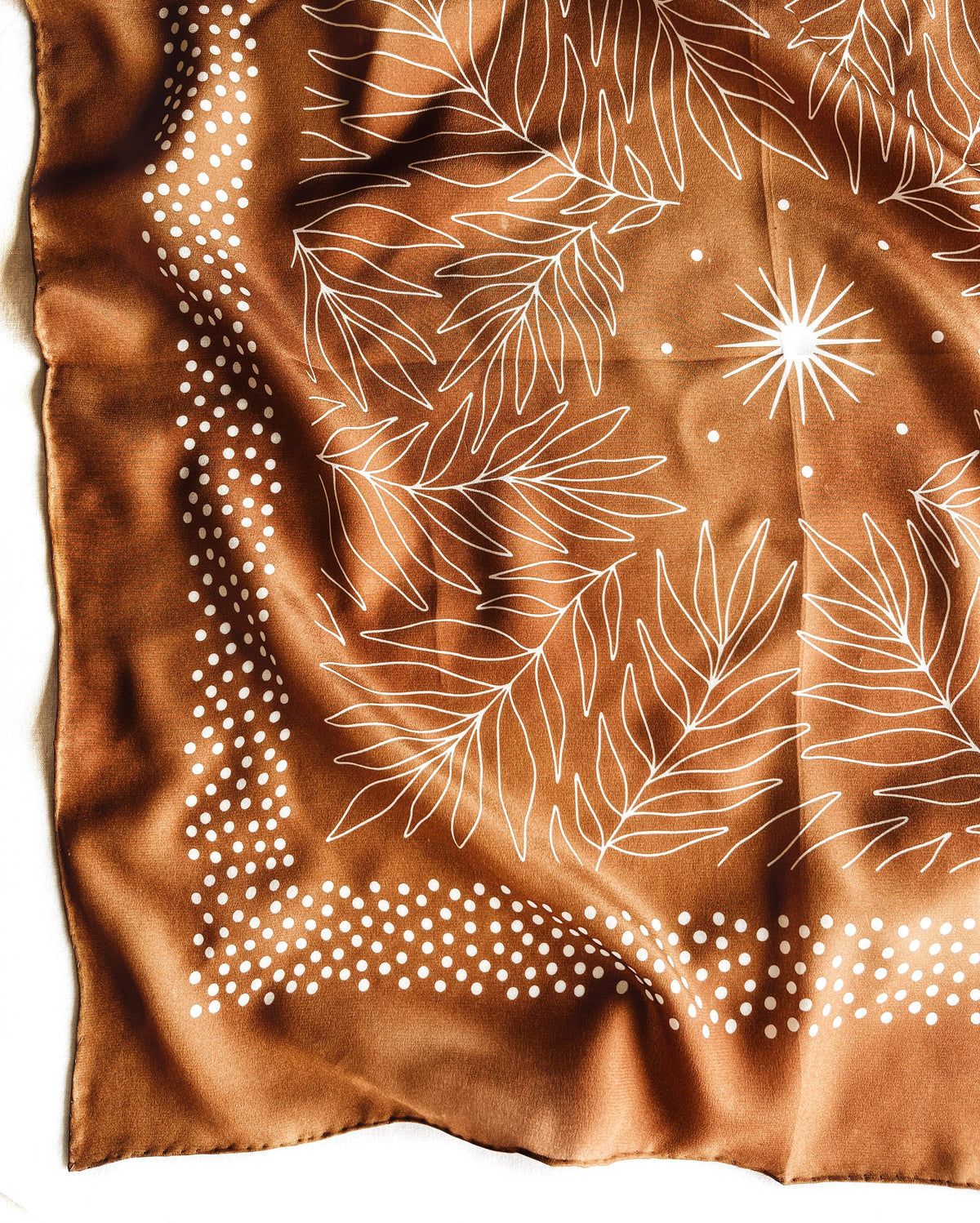 Silk scarf with brown background and white floral pattern