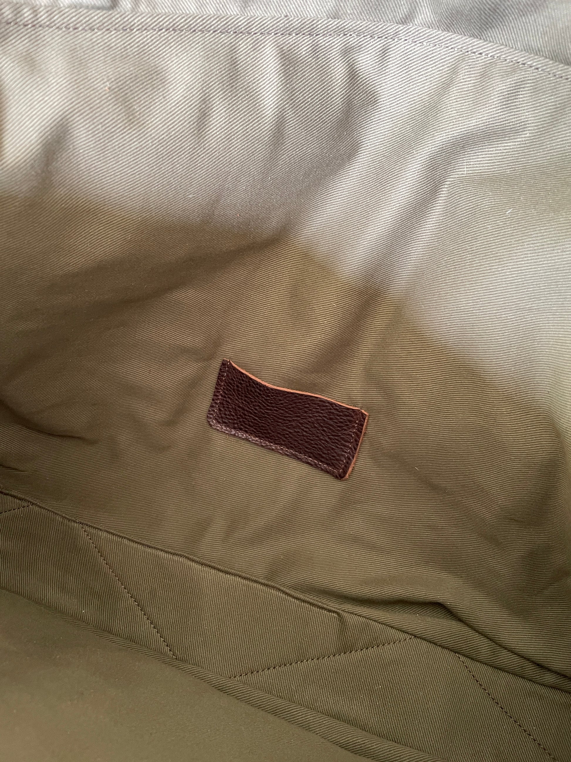 Lining of Attune birthing stool bag, showing small leather pocket for screw leg cap protectors. 