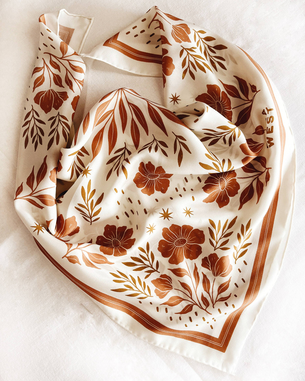 Silk scarf with white background and brown floral pattern